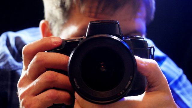 Photographer takes pictures with DSLR camera. 4K UHD