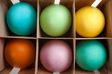 six pastel  easter eggs in a printers box