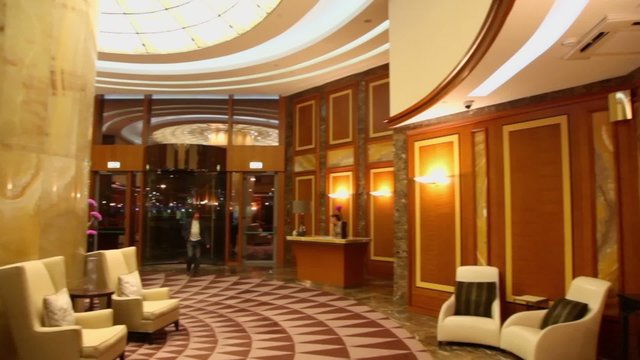Man comes to hall with girl at reception in Federation Tower of Moscow City