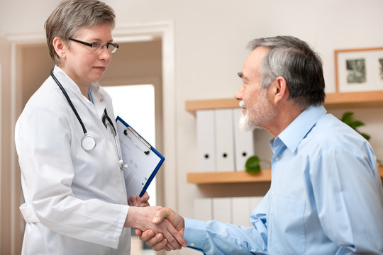 Doctor shaking hands to patient