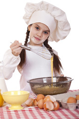 Little girl in a white apron breaks near the plate with eggs