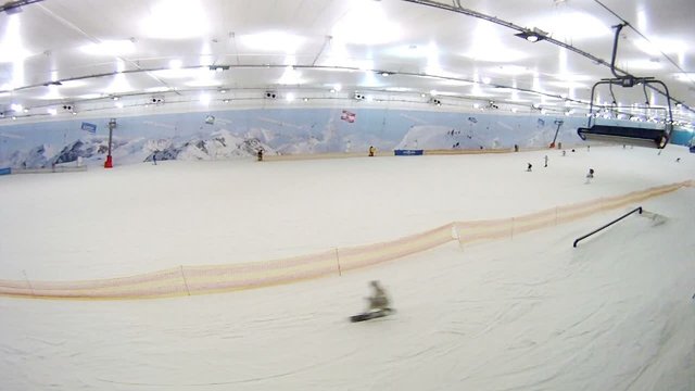 Skilift goes over snow gentle slope of mountain.