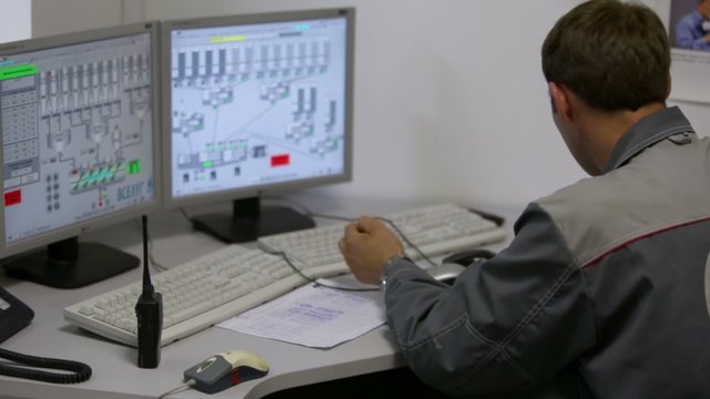 Operator works on computer at factory Caparol