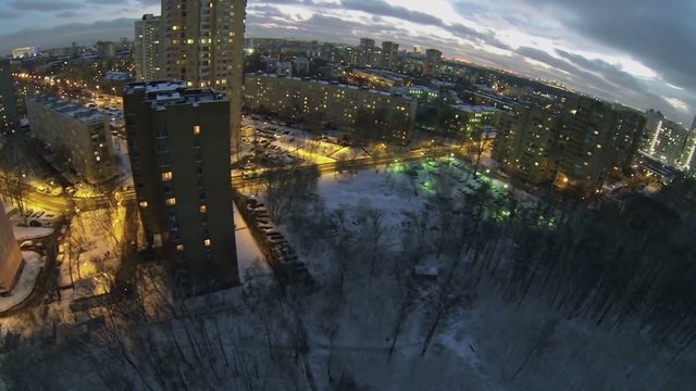 Urban sector with traffic on street at winter evening 