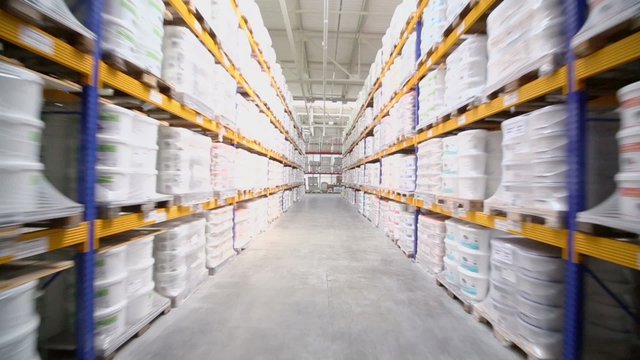 Lot of products lay on shelves in warehouse of Caparol factory