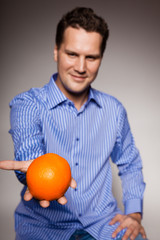 Diet and healthy nutrition. Man recommending orange