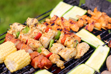 Assorted meat and vegetables on barbecue grill