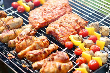 Assorted meat and vegetables on barbecue grill