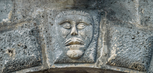 Fototapeta na wymiar Bas-relief with man's face on musium in Perast