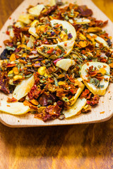 Colored spices for pasta mix on wooden spoon