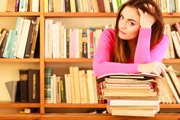Tired girl student in college library