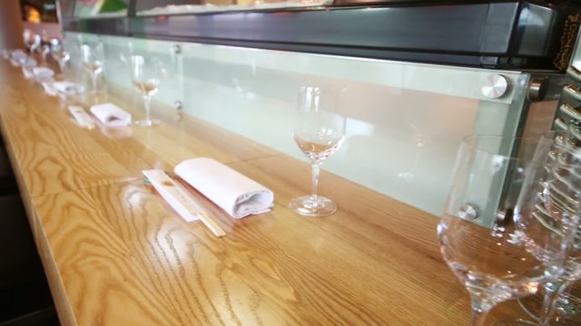 Many empty glasses on table at cozy cafe with modern interior