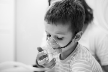 mother caring kid with aerosols inhalation