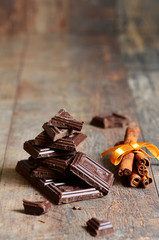 Stack of chocolate slices with mint leaf and cinnamon .