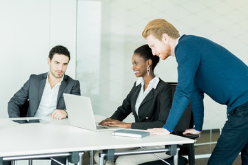 Business people discussing and brainstorming at a white desk in