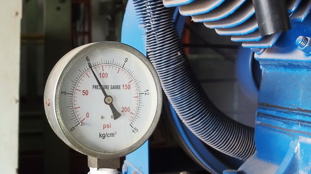 Close up pressure gauge with compressor working.