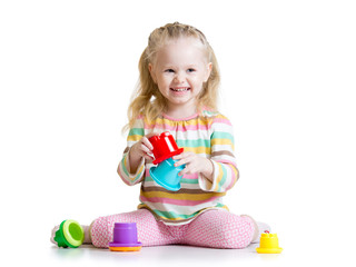 smiling child girl playing with color toys