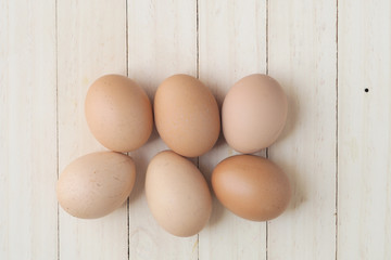 Eggs on wood plank background.