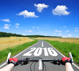 Cyclist riding a bike. Forward to the New Year 2016