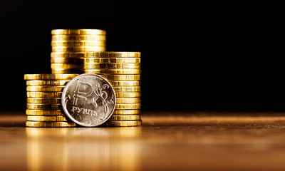 The Russian rouble coin and gold money on the desk