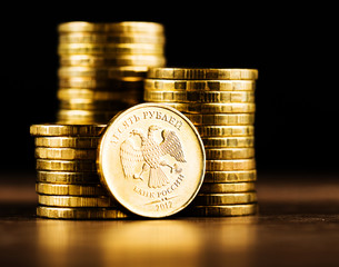 The Russian rouble coin and gold money on the desk