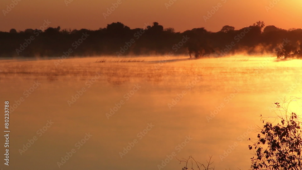 Wall mural Mist over water at sunrise, Zambezi river