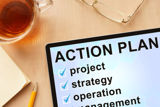 Tablet with words action plan. Business concept.