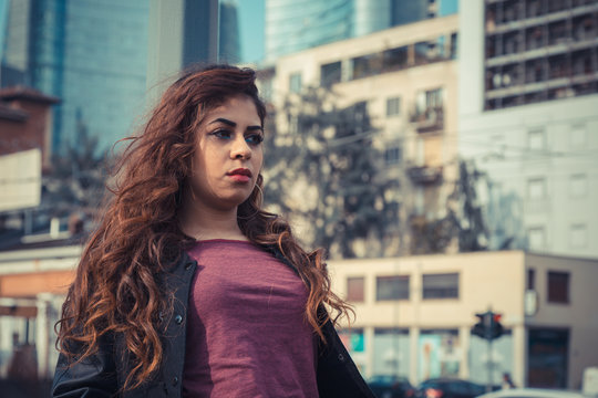 Beautiful girl posing in an urban context