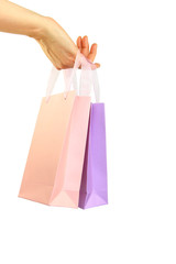 Hand holding colorful shopping bags isolated on white