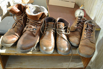 Vintage brown shoes on the old shelf at the balcony