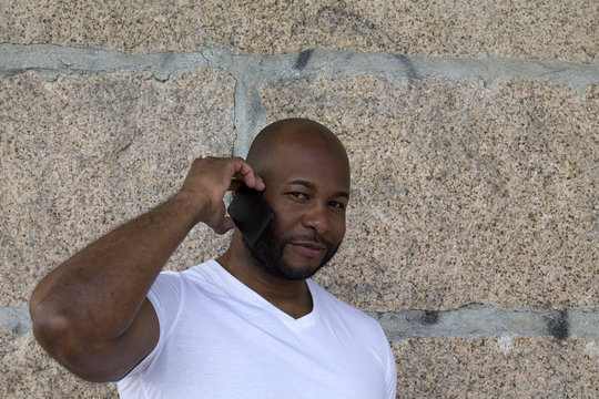 black man talking on the phone in the street