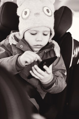 girl playing smartphone in  car