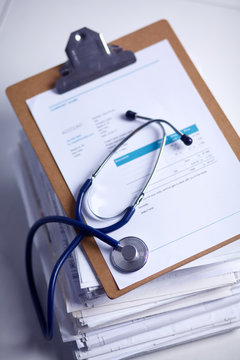 Medical stethoscope on the stack of paper