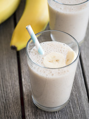 Banana milkshake on wooden background