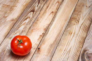Red tomato on a wooden background