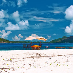 Tropical beach at Seychelles with picnic table and chairs
