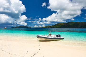 Fototapeta na wymiar Tropical beach at Seychelles with inflatable boat