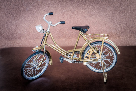 Small gold color toy bicycle