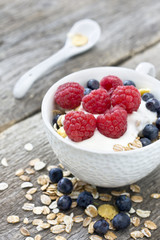 cup of muesli with raspberries and blueberries