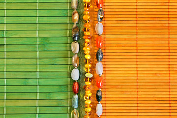 background with female ornaments on a bamboo mat