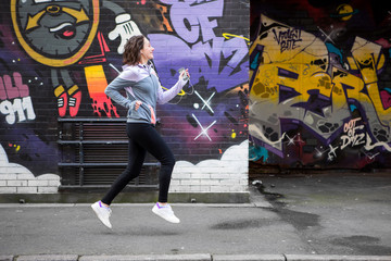 Young attractive woman running downtown