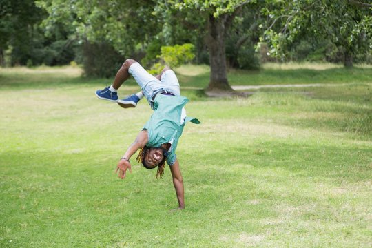 Hipster doing back flip in the park