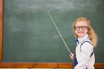 Happy pupil pointing the blackboard