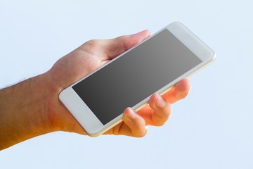 Hand holding a white smartphone
