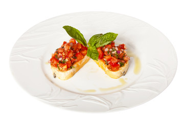 Bruschetta with red tomatoes and green basil