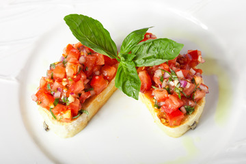 Bruschetta with red tomatoes and green basil