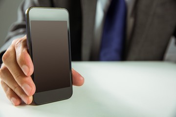 Businessman showing his smart phone