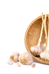 Garlics with bamboo basket on white background