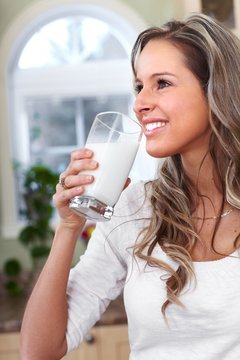 Young woman drinking milk.
