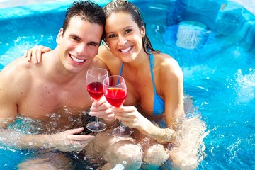 Young couple relaxing in jacuzzi.